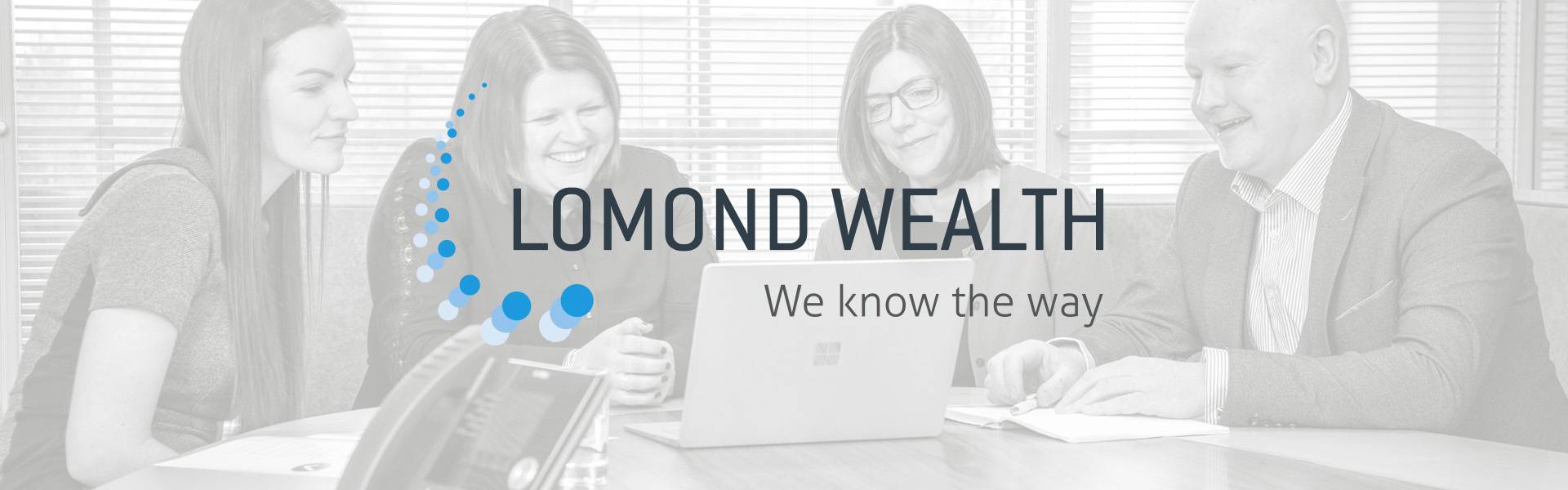 Lomond Wealth Team Around a laptop, with the logo and tagline: We know the way, in the foreground
