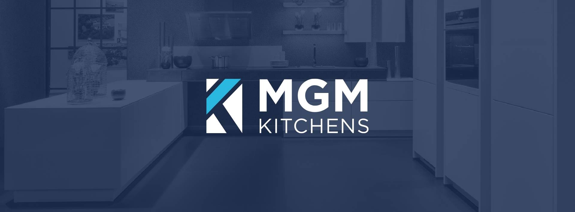 MGM Kitchens logo in front of a showroom kitchen